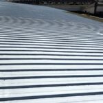 Polyurea Rayston hot-spray waterproofing on a large roof.