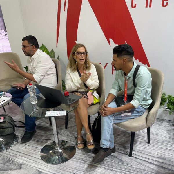 "María Del Mar, Product Manager at Krypton Chemical Spain, in a business discussion with clients from Krypton Egypt at Big 5 Construct Egypt 2025. The trade show booth features Krypton’s advanced chemical solutions for construction."
